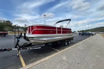 Slide: The Image of 2026 Sun Tracker Party Barge 22 DLX pontoon boat on trailer in parking lot. - 12