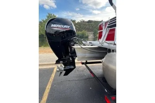 Slide: The Image of 2026 Sun Tracker Party Barge 22 DLX with Mercury outboard motor, parked near a lake. - 13