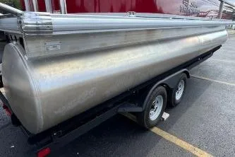 Slide: The Image of 2026 Sun Tracker Party Barge 22 DLX pontoon boat on trailer in parking lot. - 14