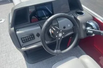 Slide: The Image of 2026 Sun Tracker Party Barge 22 DLX steering console with modern controls and dashboard. - 3