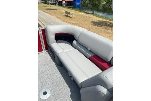 Slide: The Image of 2026 Sun Tracker Party Barge 22 DLX with comfortable seating by a lakeside. - 7
