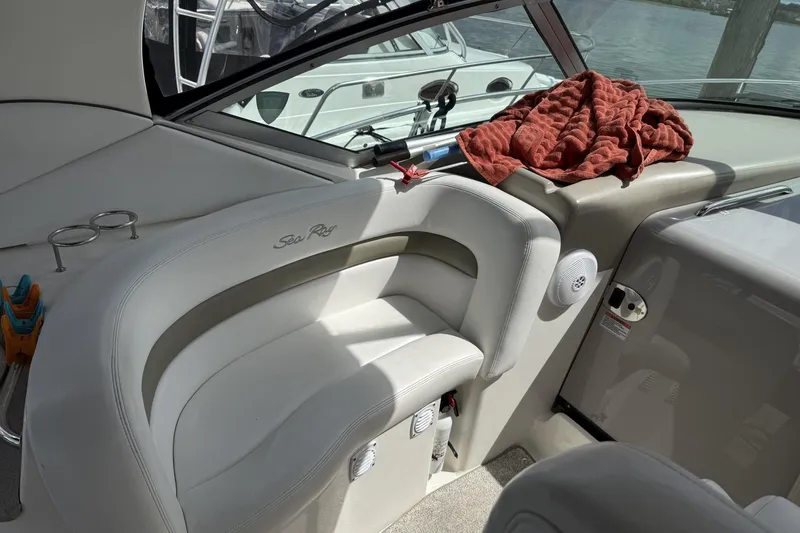Slide: The Image of Interior of 2007 Sea Ray 320 Sundancer boat with white seating and red towel. - 11