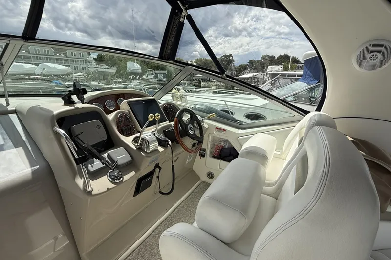 Slide: The Image of Interior of 2007 Sea Ray 320 Sundancer boat, featuring helm and seating area. - 12