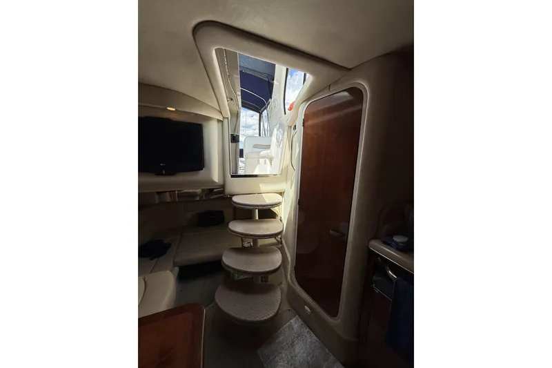 Slide: The Image of Interior of 2007 Sea Ray 320 Sundancer with steps, seating, and a TV. - 14