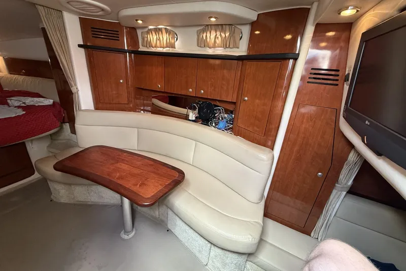 Slide: The Image of Interior of 2007 Sea Ray 320 Sundancer with wood cabinetry and beige seating. - 15