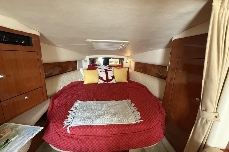 Slide: The Image of Interior cabin of 2007 Sea Ray 320 Sundancer with cozy bed and nautical decor. - 17