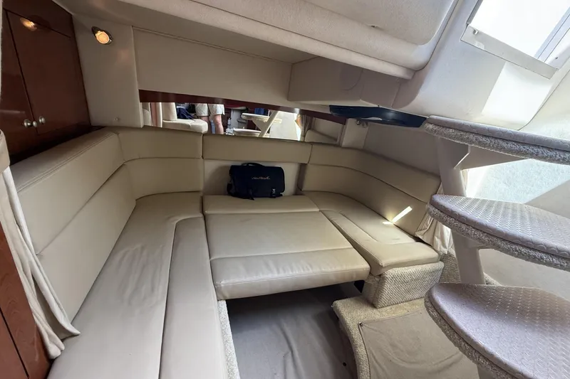 Slide: The Image of Interior of 2007 Sea Ray 320 Sundancer with beige leather seating and carpeted stairs. - 18