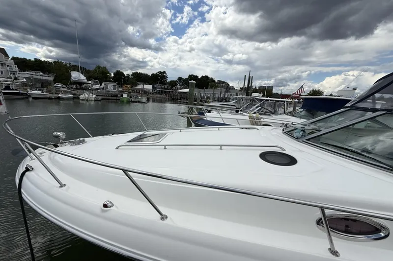 Slide: The Image of 2007 Sea Ray 320 Sundancer docked at a marina under cloudy skies. - 5