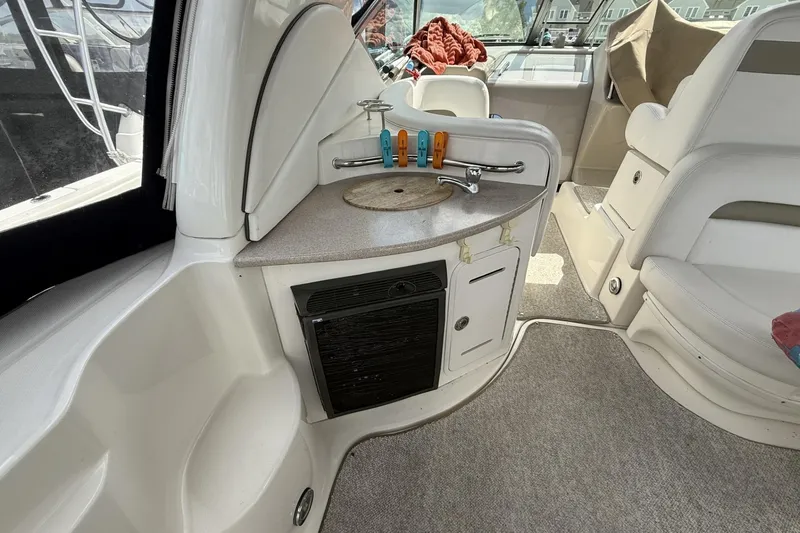 Slide: The Image of 2007 Sea Ray 320 Sundancer interior with kitchenette and seating area. - 8