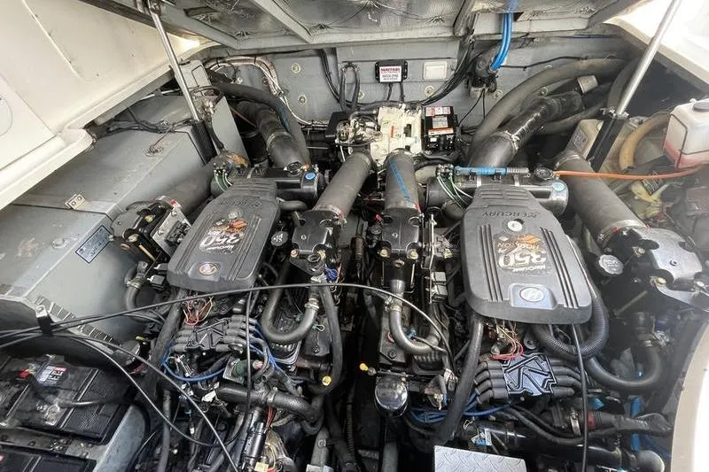 Slide: The Image of Engine compartment of a 2003 Sea Ray 320 Sundancer with dual Mercury engines. - 14