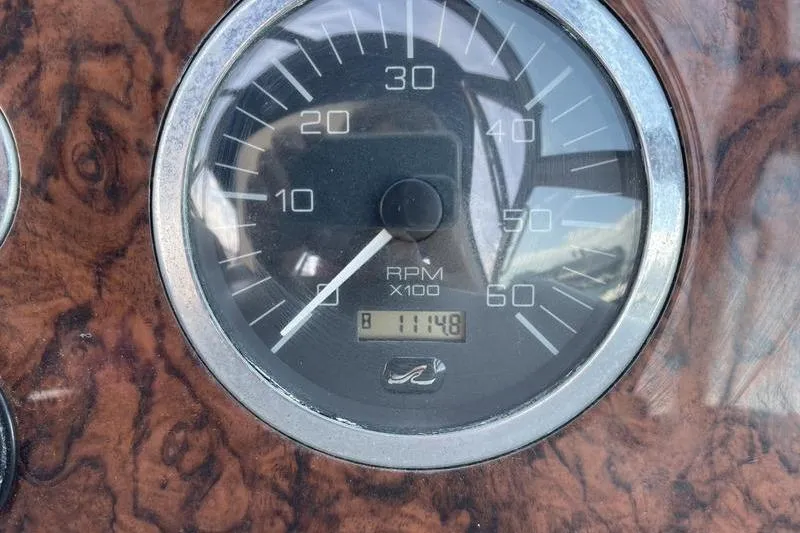 Slide: The Image of Close-up of a 2003 Sea Ray 320 Sundancer RPM gauge displaying 1114.8 hours. - 17