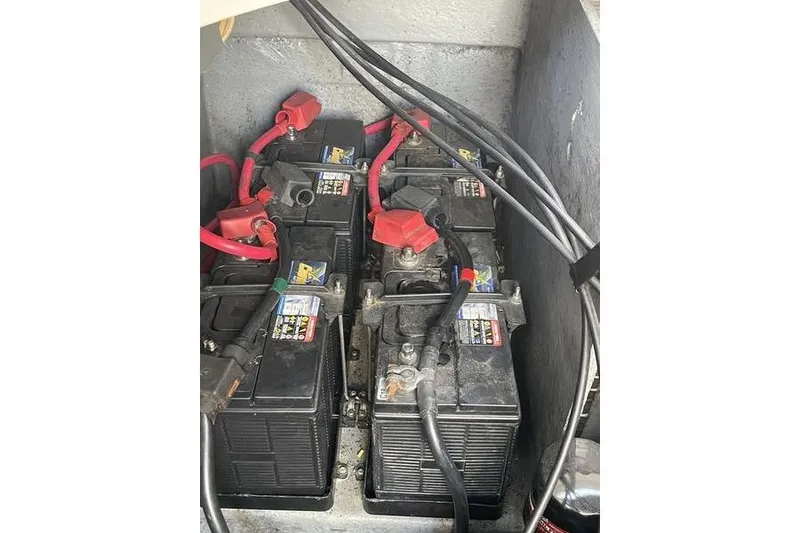 Slide: The Image of Batteries in a 2003 Sea Ray 320 Sundancer boat with red and black cables. - 3