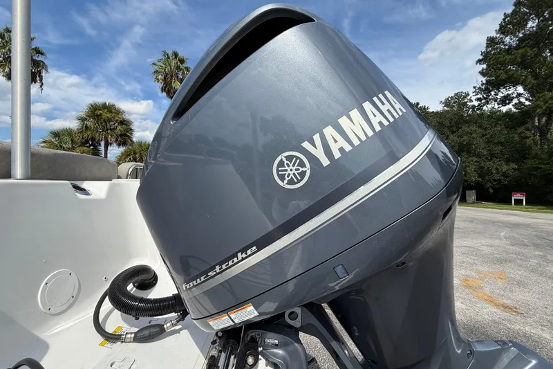 Slide: The Image of Yamaha four-stroke engine on 2021 Sea Fox 248 Commander boat, outdoors with palm trees. - 11