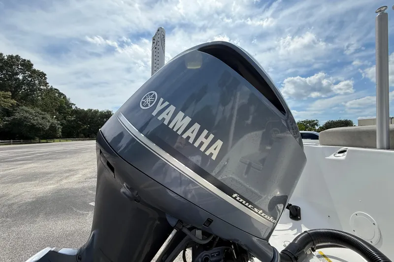 Slide: The Image of Yamaha outboard motor on 2021 Sea Fox 248 Commander boat under a partly cloudy sky. - 12