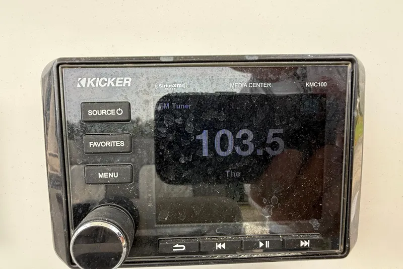 Slide: The Image of Kicker media center display on 2021 Sea Fox 248 Commander, tuned to 103.5 FM. - 18
