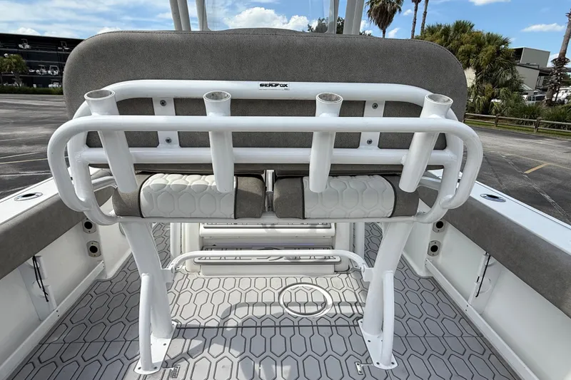 Slide: The Image of 2021 Sea Fox 248 Commander boat interior with rod holders and cushioned seating. - 21