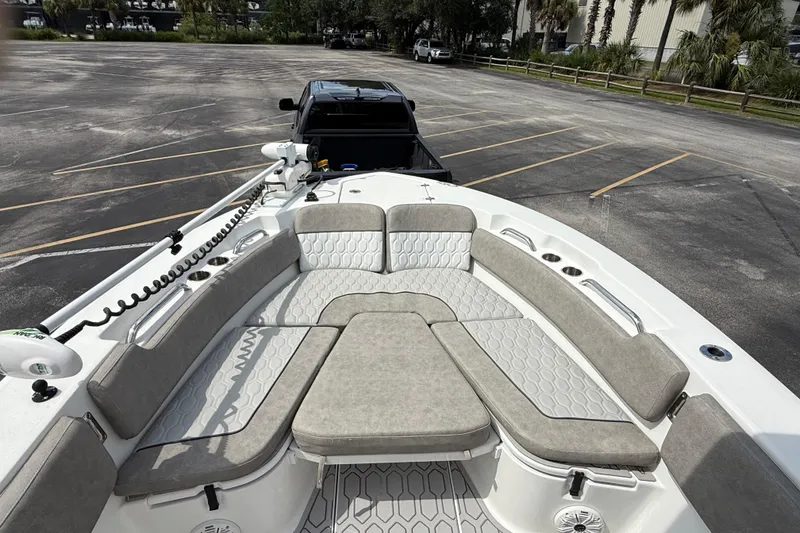 Slide: The Image of 2021 Sea Fox 248 Commander boat interior with cushioned seating in a parking lot. - 22