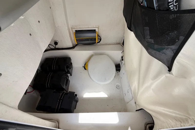 Slide: The Image of 2021 Sea Fox 248 Commander boat storage compartment with batteries and charger. - 28