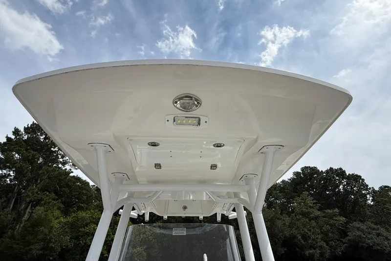 Slide: The Image of 2021 Sea Fox 248 Commander boat T-top with LED lights against a cloudy sky. - 29