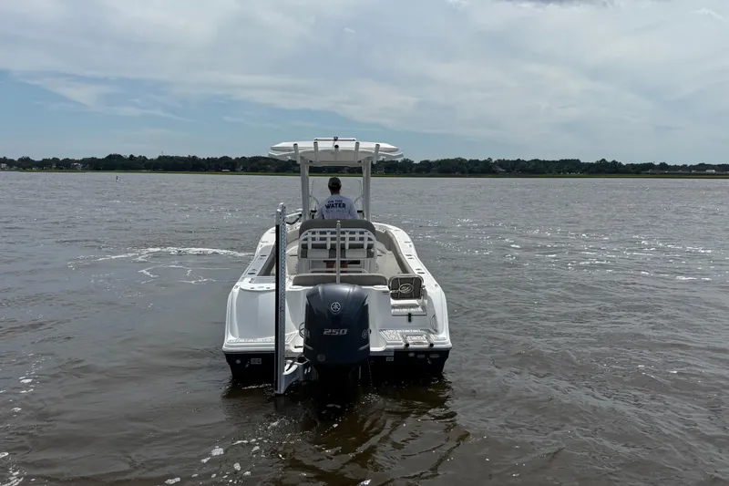 Slide: The Image of 2021 Sea Fox 248 Commander boat cruising on open water, rear view. - 5