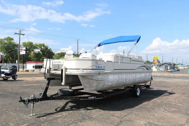 Slide: The Image of 2005 G3 SunCatcher LX 22 Fish & Cruise pontoon boat on trailer, blue canopy. - 3