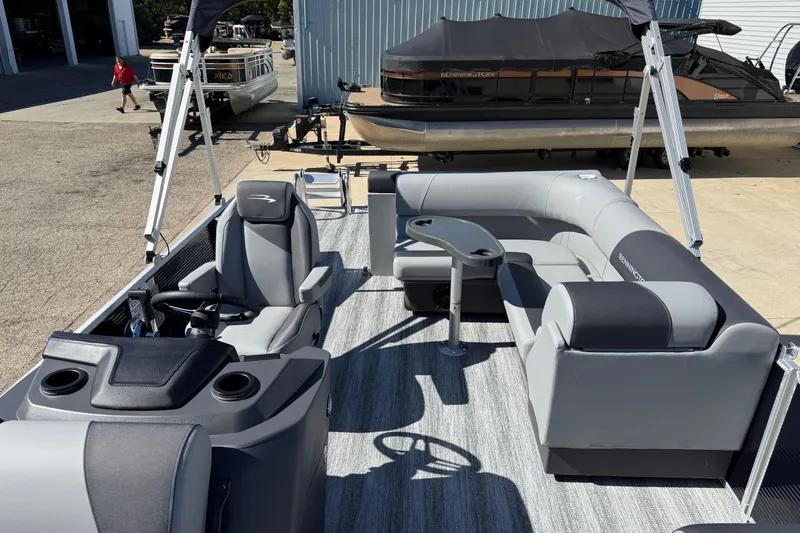 Slide: The Image of 2026 Bennington 22 SLJ boat storage compartment with cushioned seating. - 14