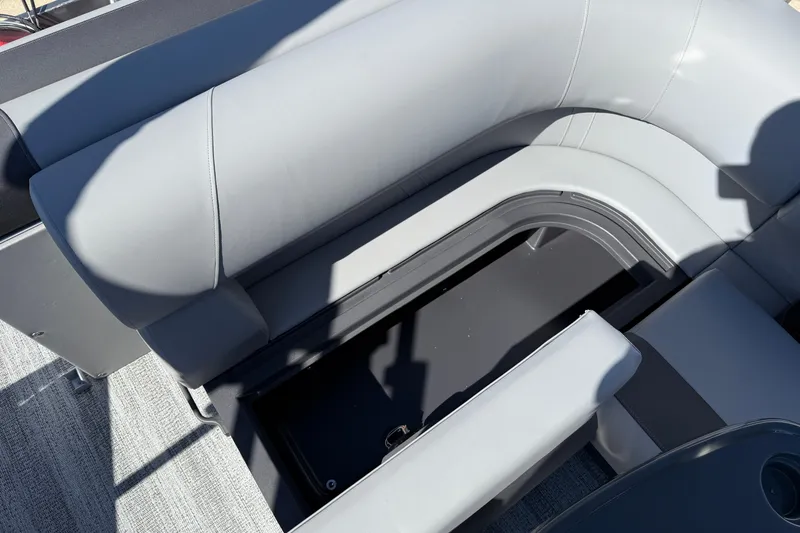 Slide: The Image of 2026 Bennington 22 SLJ pontoon boat storage compartment with battery and seating. - 22