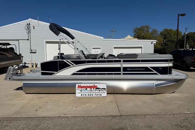 Slide: The Image of 2026 Bennington 22 SLJ pontoon boat displayed outside a showroom. - 3