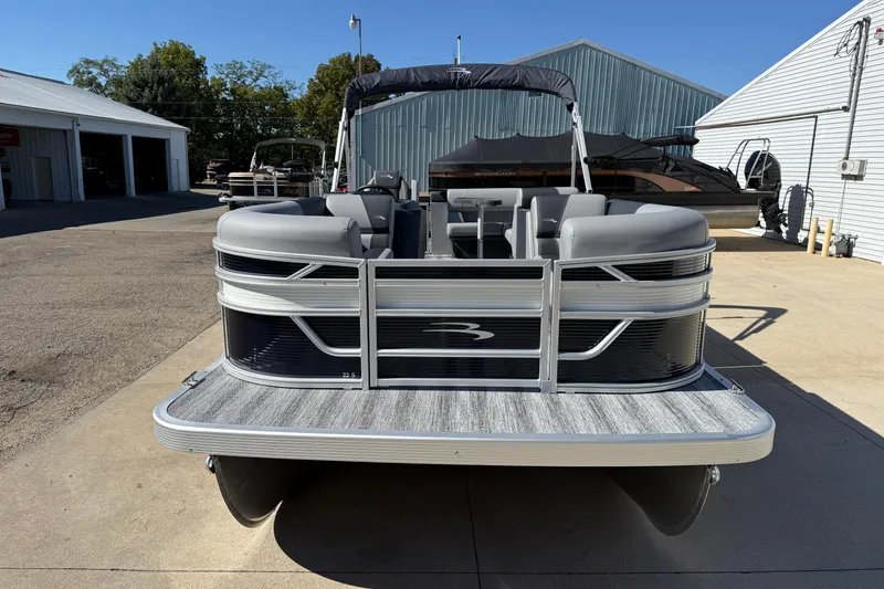 Slide: The Image of 2026 Bennington 22 SLJ pontoon boat parked on driveway, featuring sleek design and modern amenities. - 5