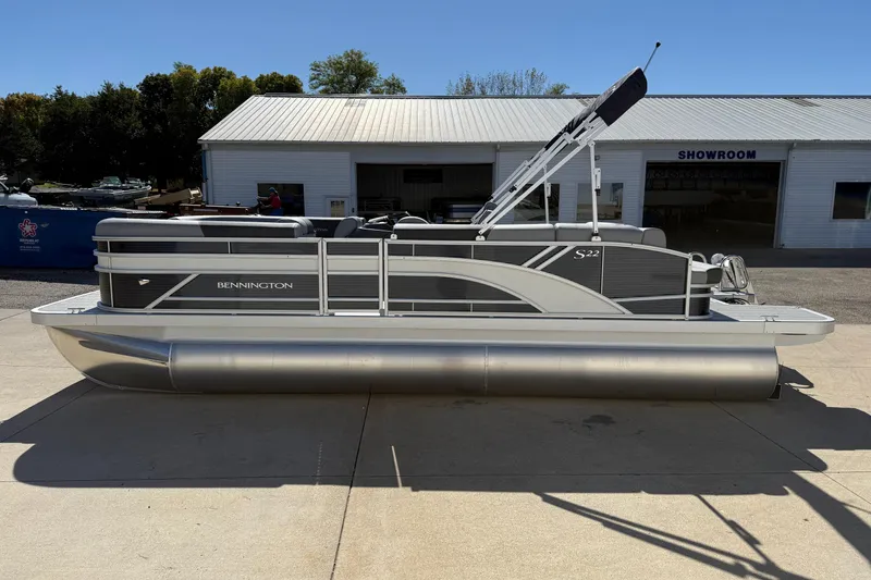 Slide: The Image of 2026 Bennington 22 SLJ pontoon boat parked outdoors on a sunny day. - 7
