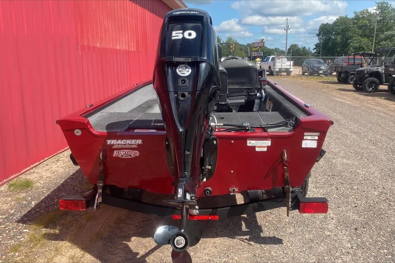 Slide: The Image of 2021 Tracker Super Guide V-16 SC boat with Mercury 50 engine, parked outdoors. - 2