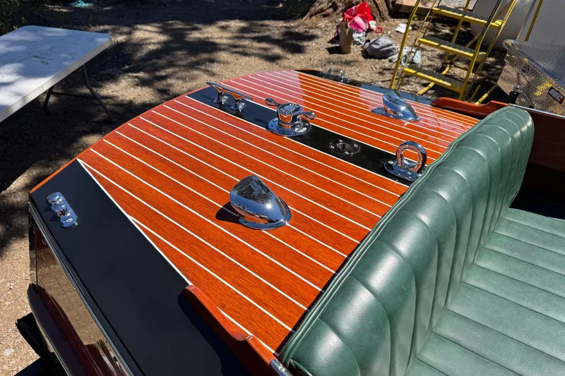 Slide: The Image of 1987 Grand Craft Triple Cockpit Runabout with polished wood deck and green leather seats. - 13