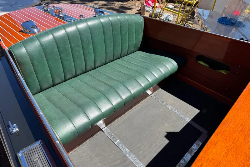 Slide: The Image of 1987 Grand Craft Triple Cockpit Runabout with green leather seating and polished wood finish. - 14
