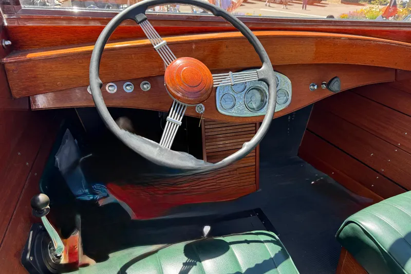 Slide: The Image of 1987 Grand Craft Triple Cockpit Runabout interior with wooden dashboard and vintage steering wheel. - 16