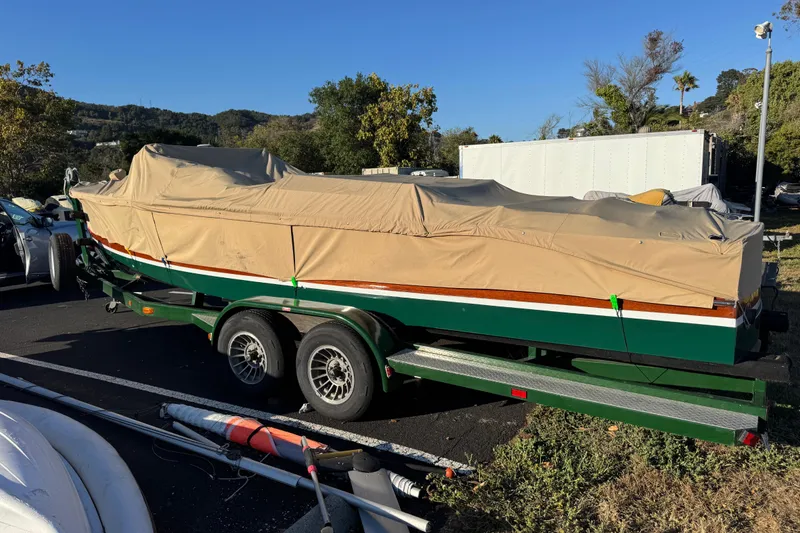 Slide: The Image of 1987 Grand Craft Triple Cockpit Runabout covered on trailer, parked outdoors. - 20