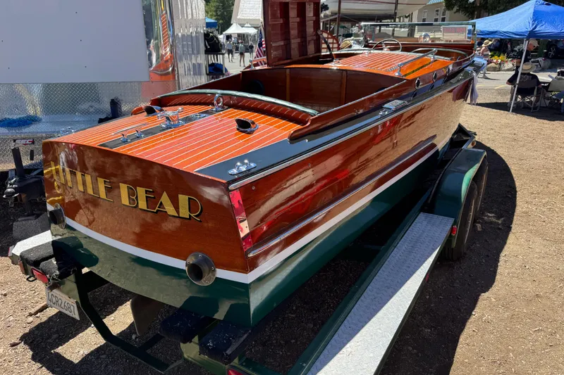 Slide: The Image of 1987 Grand Craft Triple Cockpit Runabout "Little Bear" on trailer at outdoor event. - 5