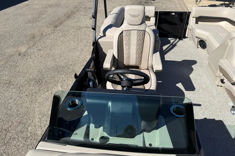 Slide: The Image of 2026 Bennington 24 M Fastback boat interior with steering wheel and seating. - 14