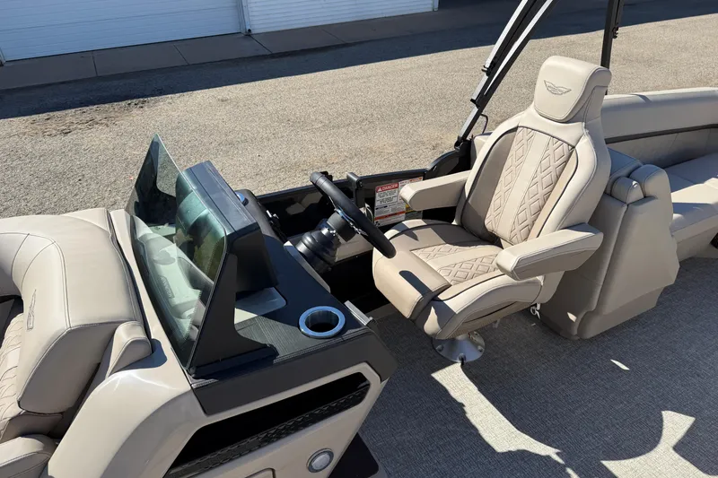 Slide: The Image of 2026 Bennington 24 M Fastback boat interior with luxurious seating and modern dashboard. - 15