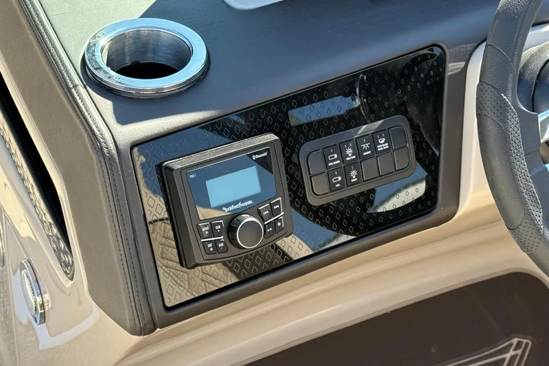 Slide: The Image of Dashboard of 2026 Bennington 24 M Fastback with control panel and cup holder. - 18