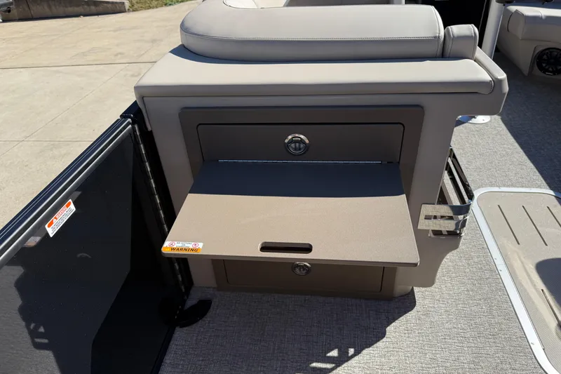 Slide: The Image of 2026 Bennington 24 M Fastback boat interior with storage compartment and cushioned seating. - 21