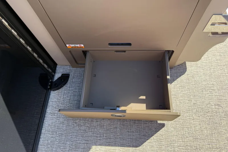 Slide: The Image of Open storage compartment in 2026 Bennington 24 M Fastback boat. - 25