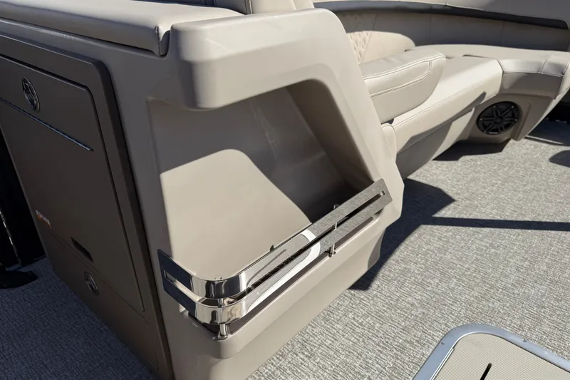 Slide: The Image of 2026 Bennington 24 M Fastback boat interior with beige seating and storage compartment. - 26