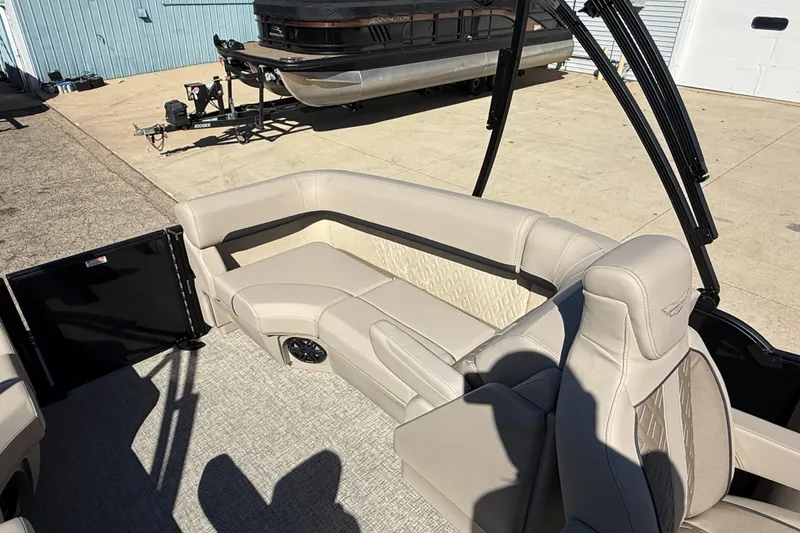 Slide: The Image of 2026 Bennington 24 M Fastback boat interior with beige seating and modern design. - 29