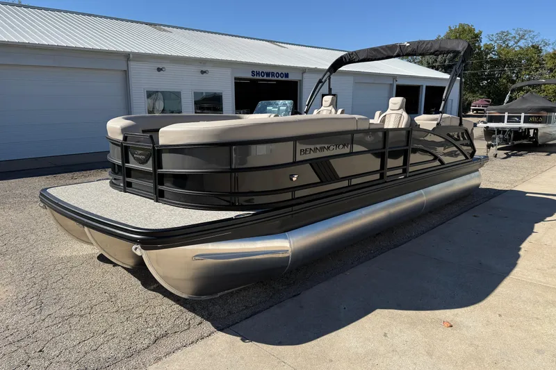 Slide: The Image of 2026 Bennington 24 M Fastback pontoon boat displayed outside a showroom. - 3