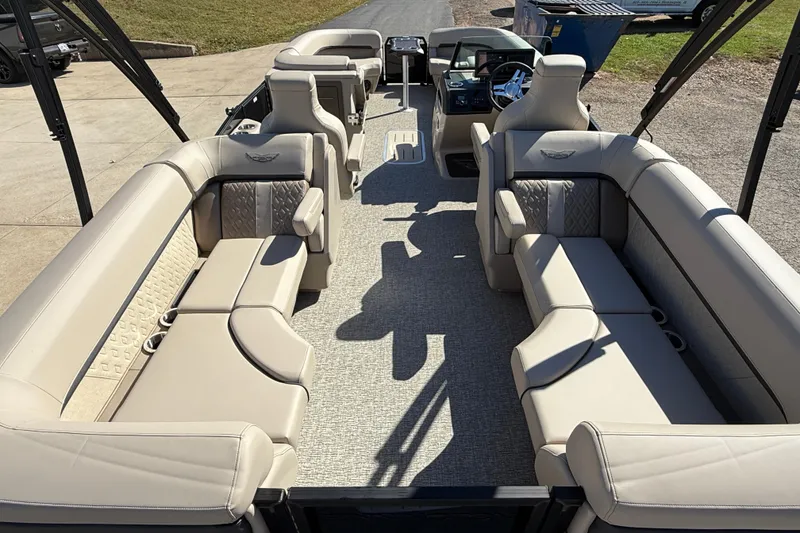 Slide: The Image of 2026 Bennington 24 M Fastback pontoon boat with luxurious beige seating and modern dashboard. - 31