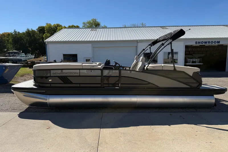 Slide: The Image of 2026 Bennington 24 M Fastback pontoon boat parked outside a showroom. - 4
