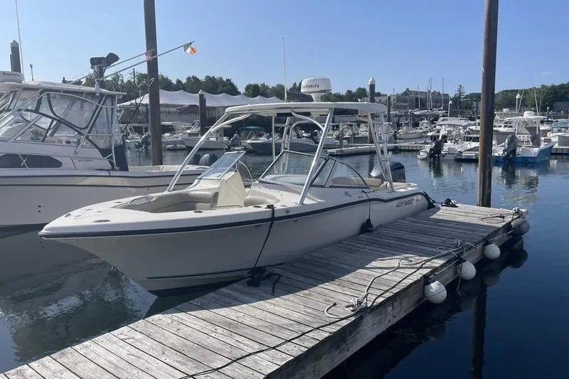 Slide: The Image of 2021 Key West 239 DFS boat docked at a marina on a sunny day. - 1