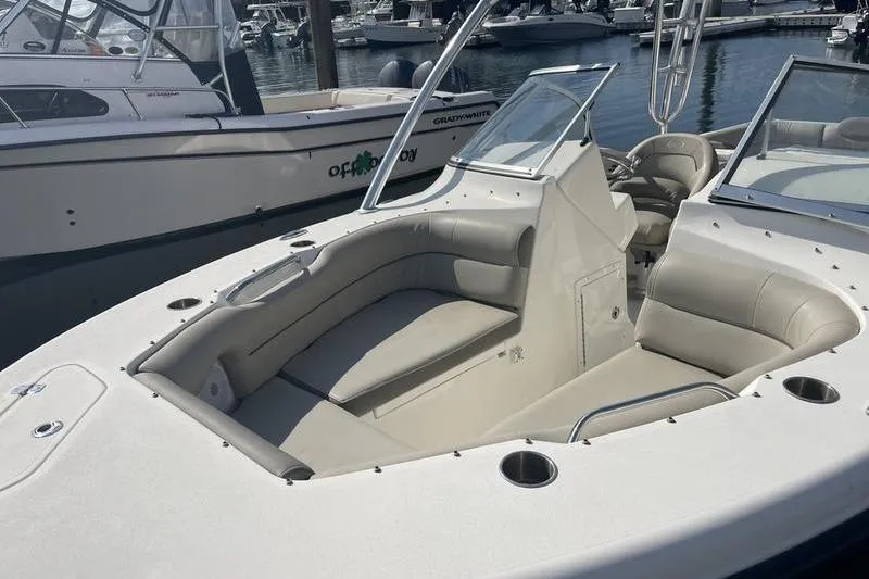 Slide: The Image of 2021 Key West 239 DFS boat with spacious seating at a marina. - 4