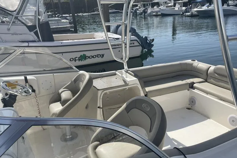 Slide: The Image of 2021 Key West 239 DFS boat interior with seating, docked in marina. - 6