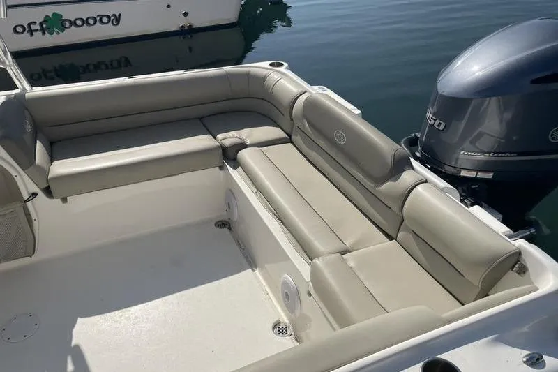 Slide: The Image of 2021 Key West 239 DFS boat with beige seating and Yamaha outboard motor. - 7